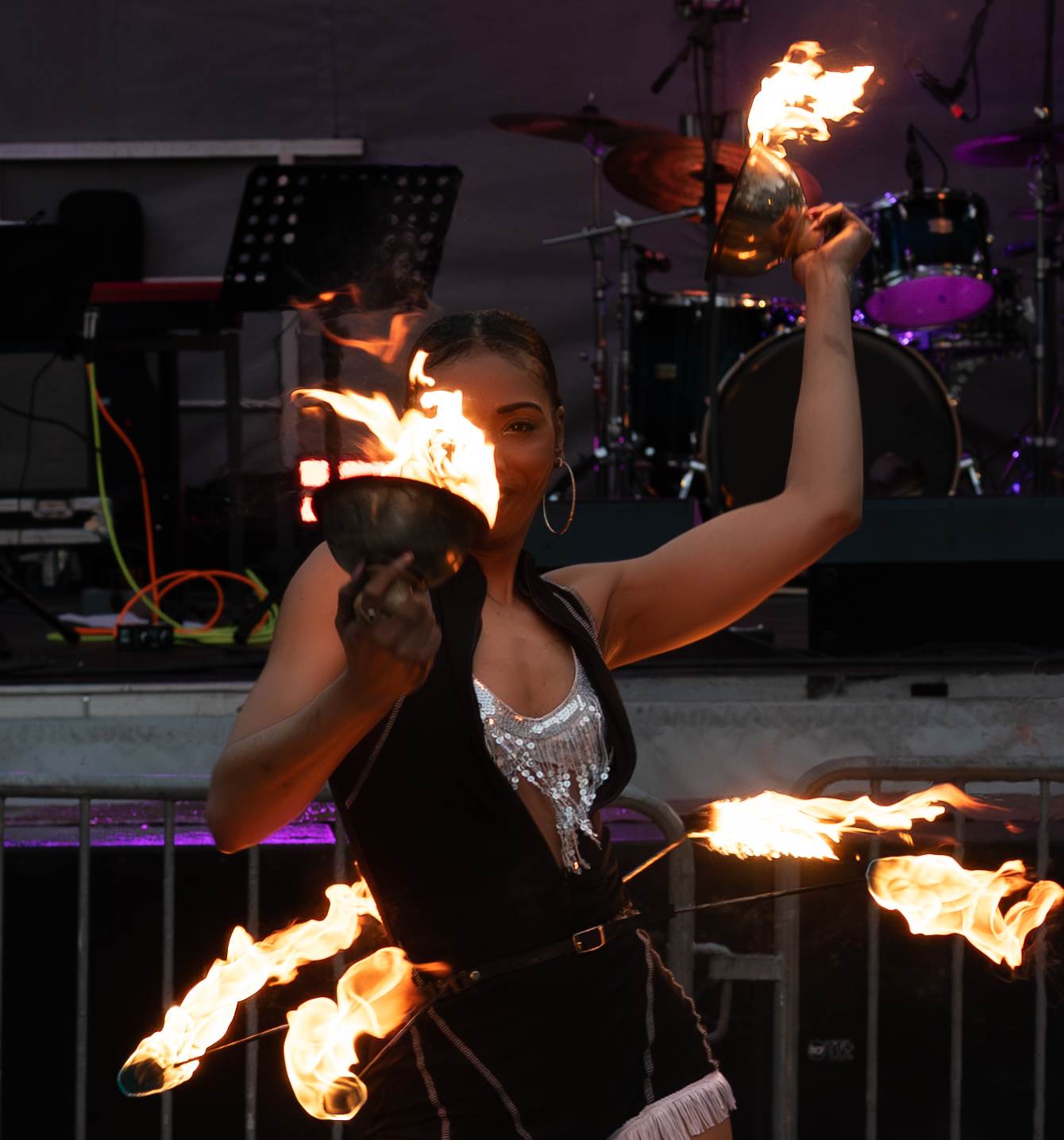 Talented female fire dancer performing with flaming bowls at Street Feast event in Charlottetown PEI - Eastside Photography