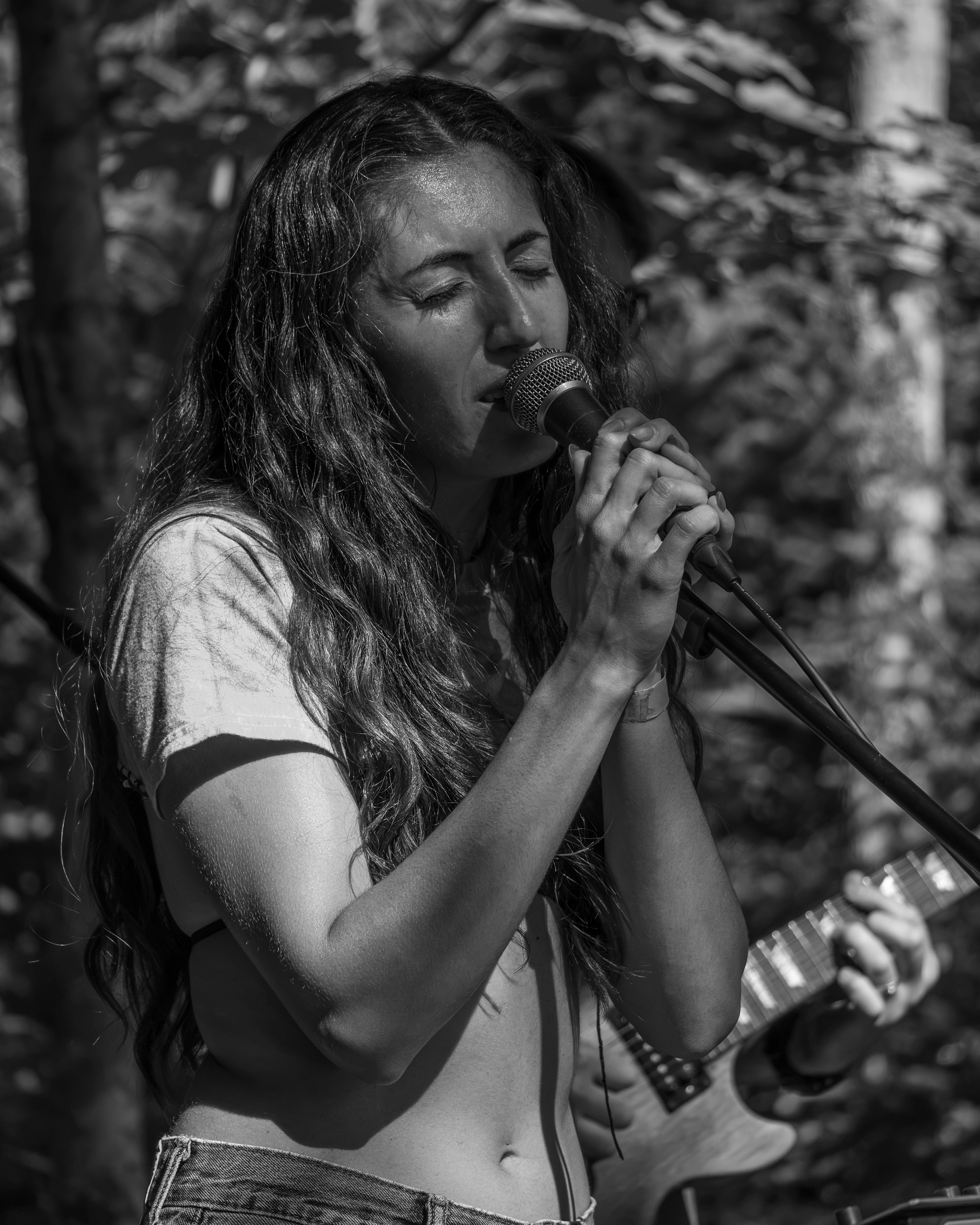 Lead vocalist singing during a live outdoor music event in Charlottetown PEI - Eastside Photography
