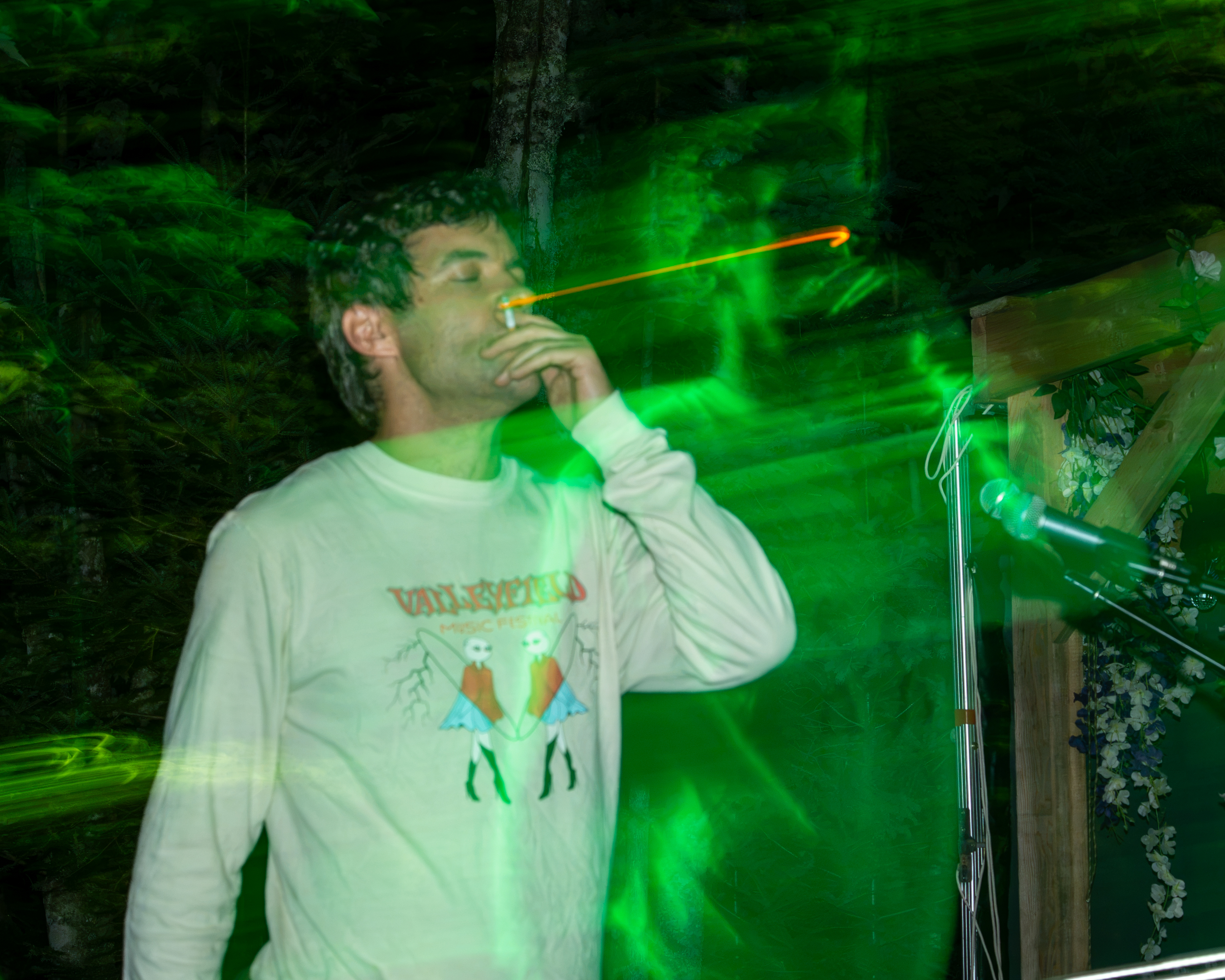 Live music artist performing on stage under dramatic green concert lighting in Charlottetown PEI - Eastside Photography