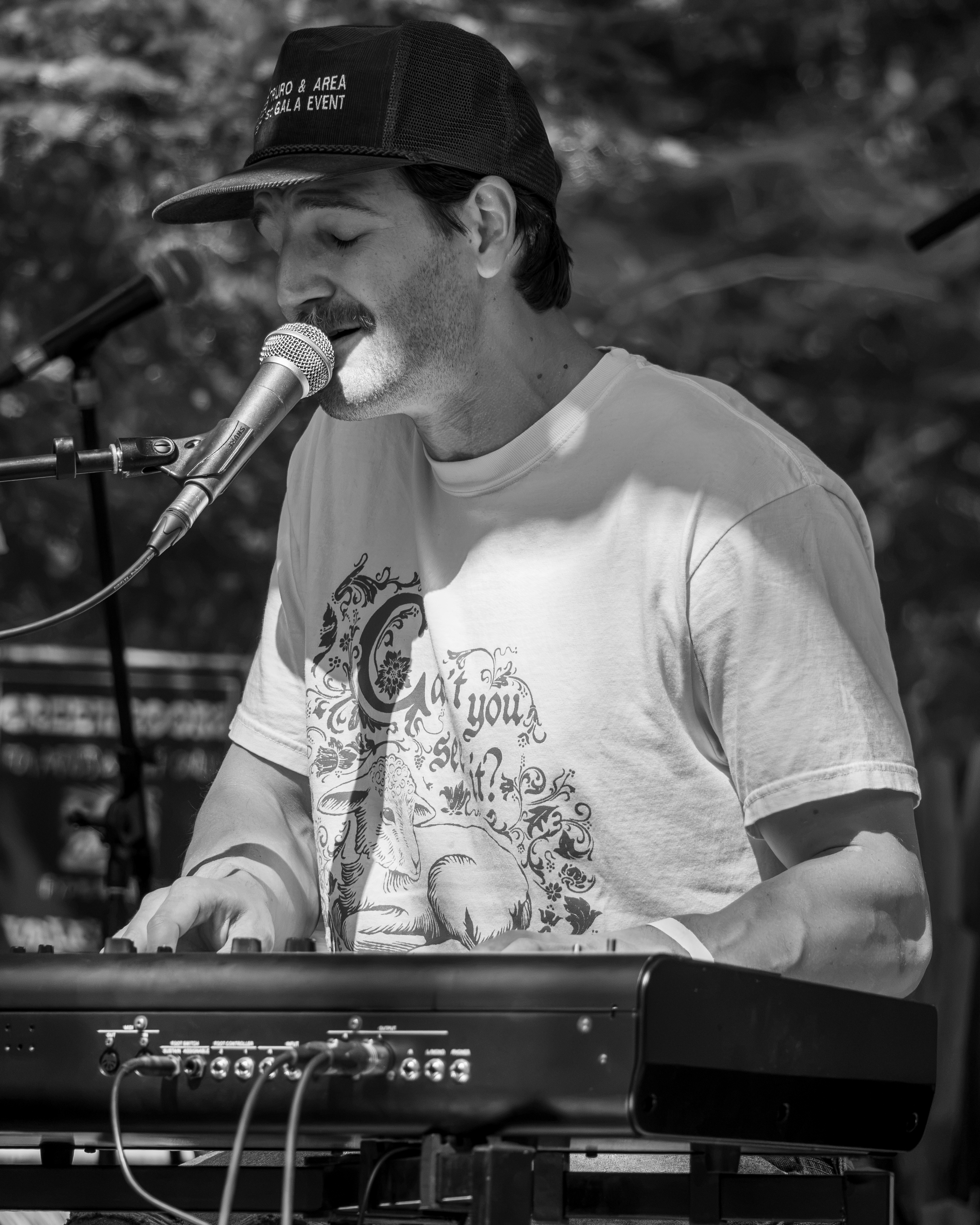 Live band keyboardist performing on stage at a Prince Edward Island outdoor concert festival - Eastside Photography