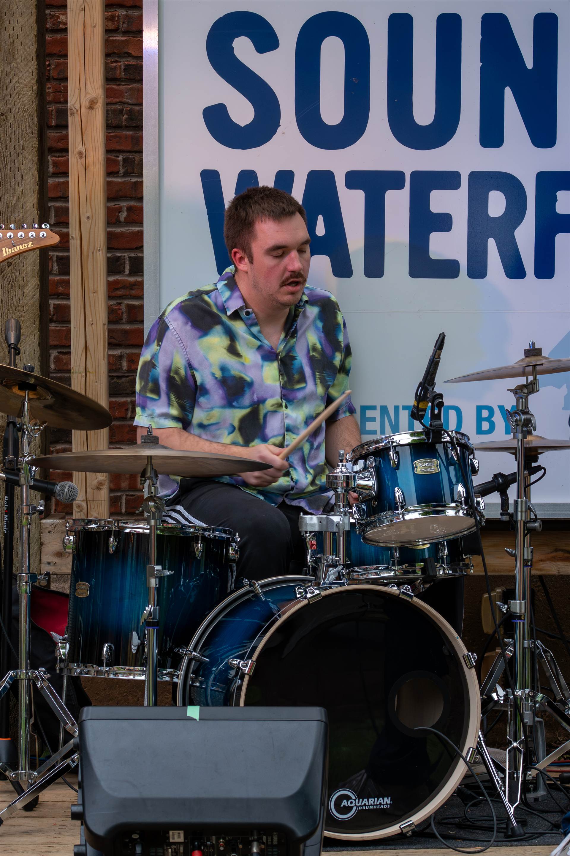 Musicians playing live at a lively Prince Edward Island outdoor concert - Eastside Photography band promo