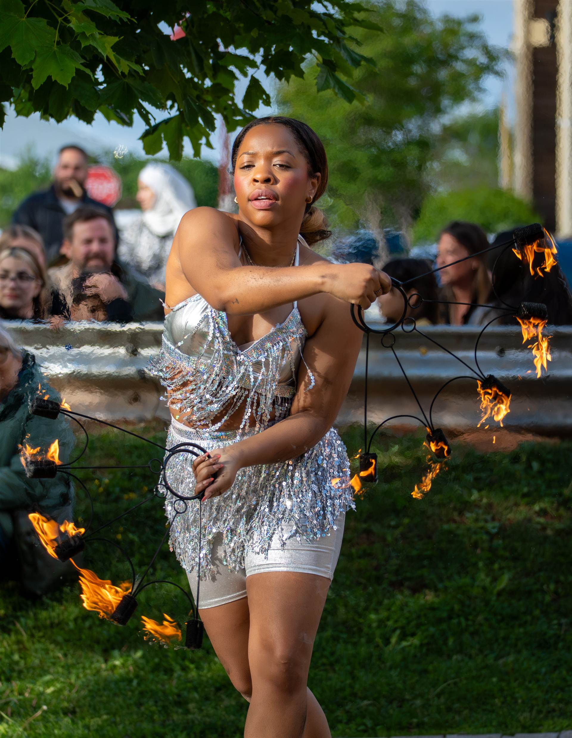 Street performer posing with fire bowls during street festival in Charlottetown PEI - Eastside Photography event coverage
