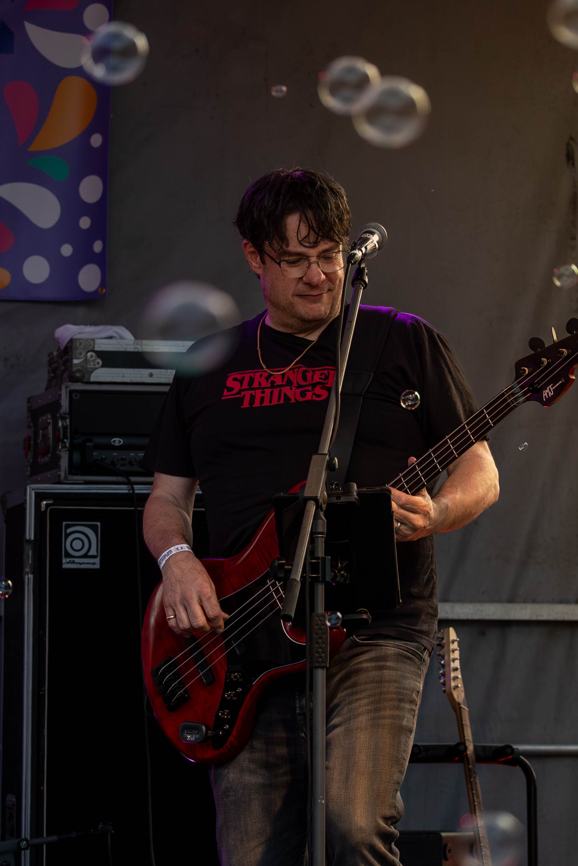 Live band bass guitarist performing on stage at a Prince Edward Island concert - Eastside Photography