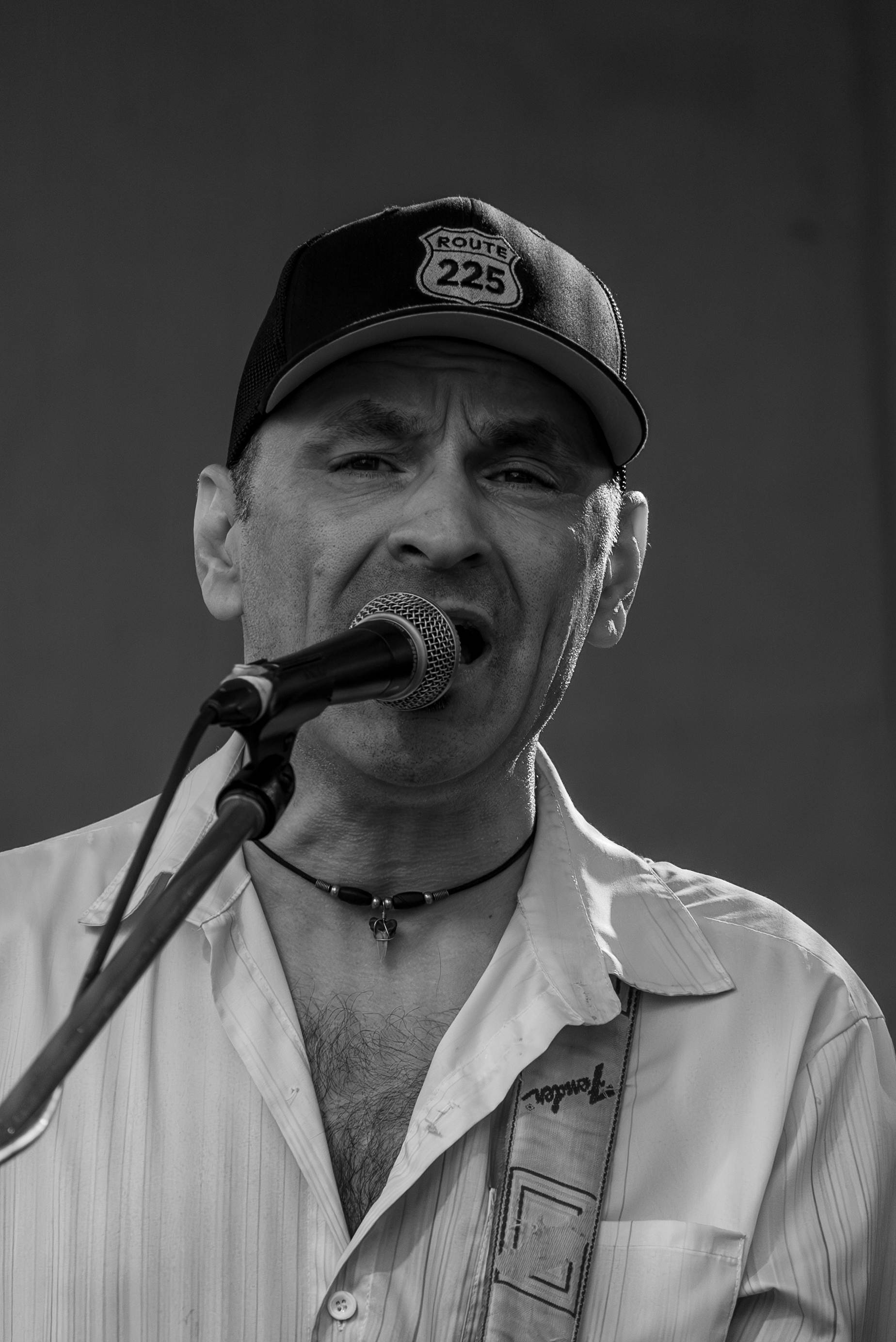 Male vocalist with cap performing live set at a Prince Edward Island concert - Eastside Photography close-up portrait