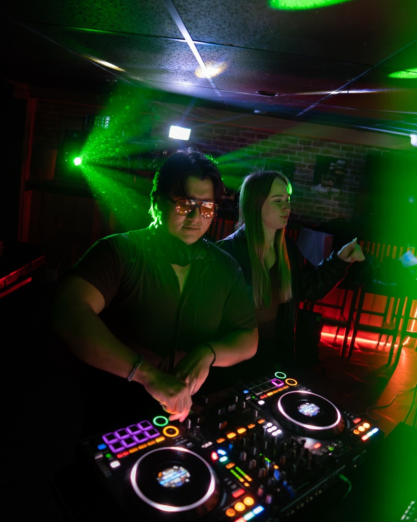 DJ performing at a PEI club under green laser lights and smoke machine - Eastside Photography atmosphere shot