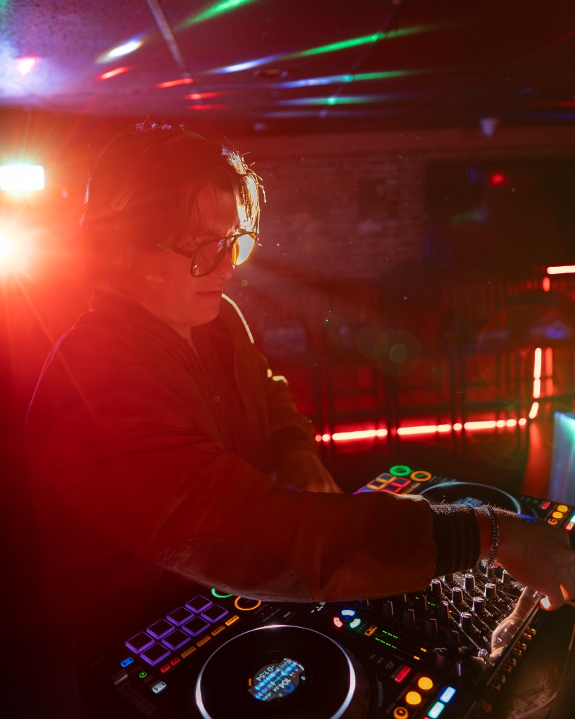 DJ performing at a packed Charlottetown club gig under red lasers and stage lights - Eastside Photography PEI live event coverage