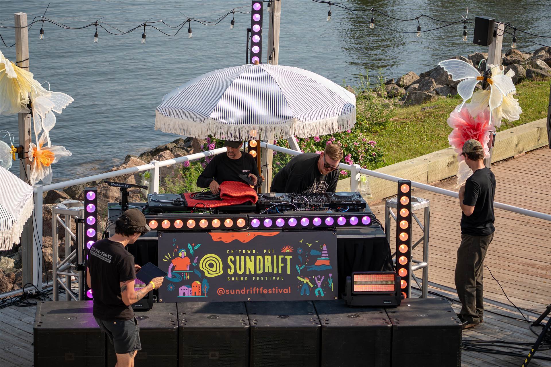 DJ in Represent shirt raising hand at Sundrift Sound Festival Charlottetown PEI - Eastside Photography