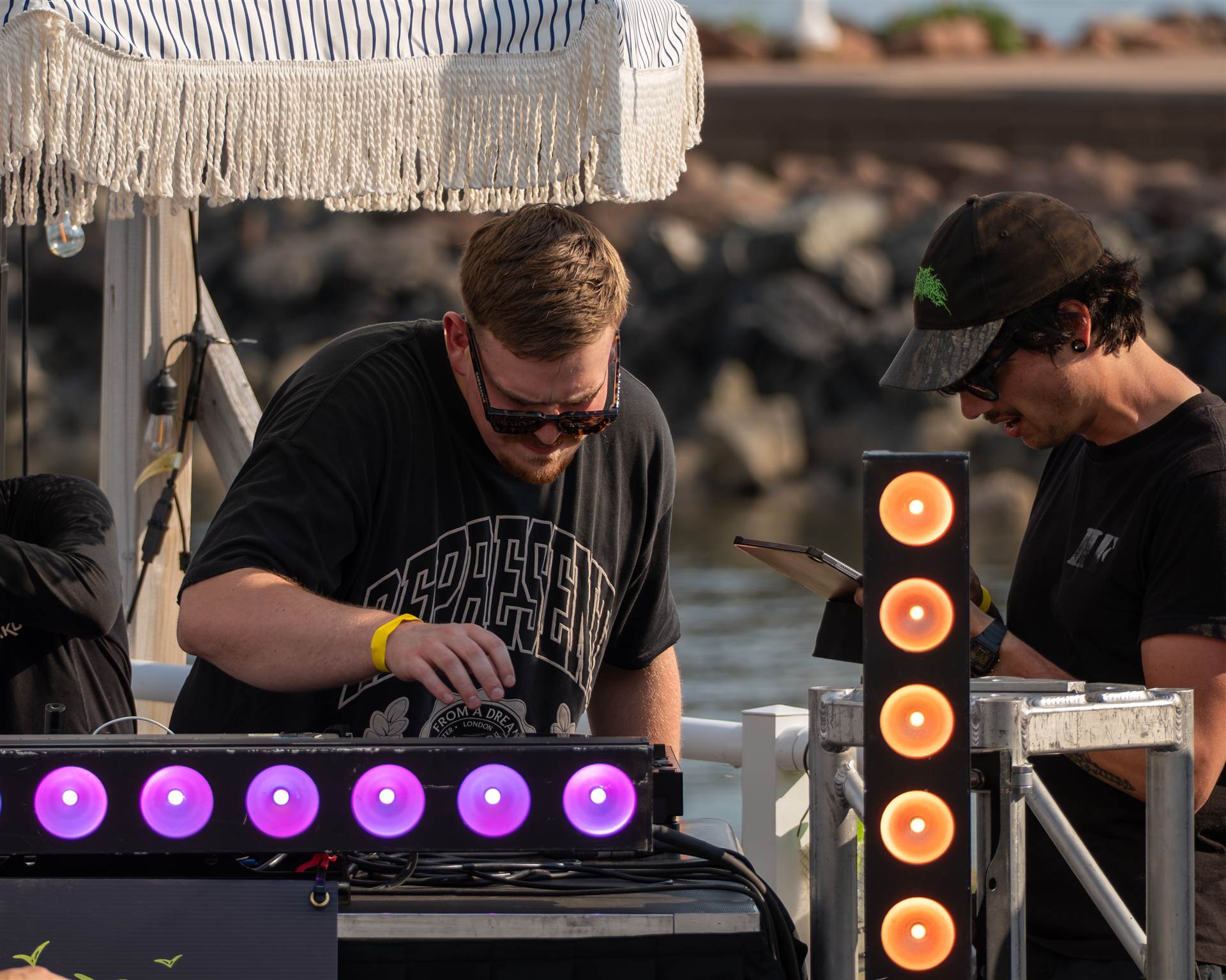 DJ leaning over Pioneer DJ controller at Sundrift waterfront festival PEI - Eastside Photography