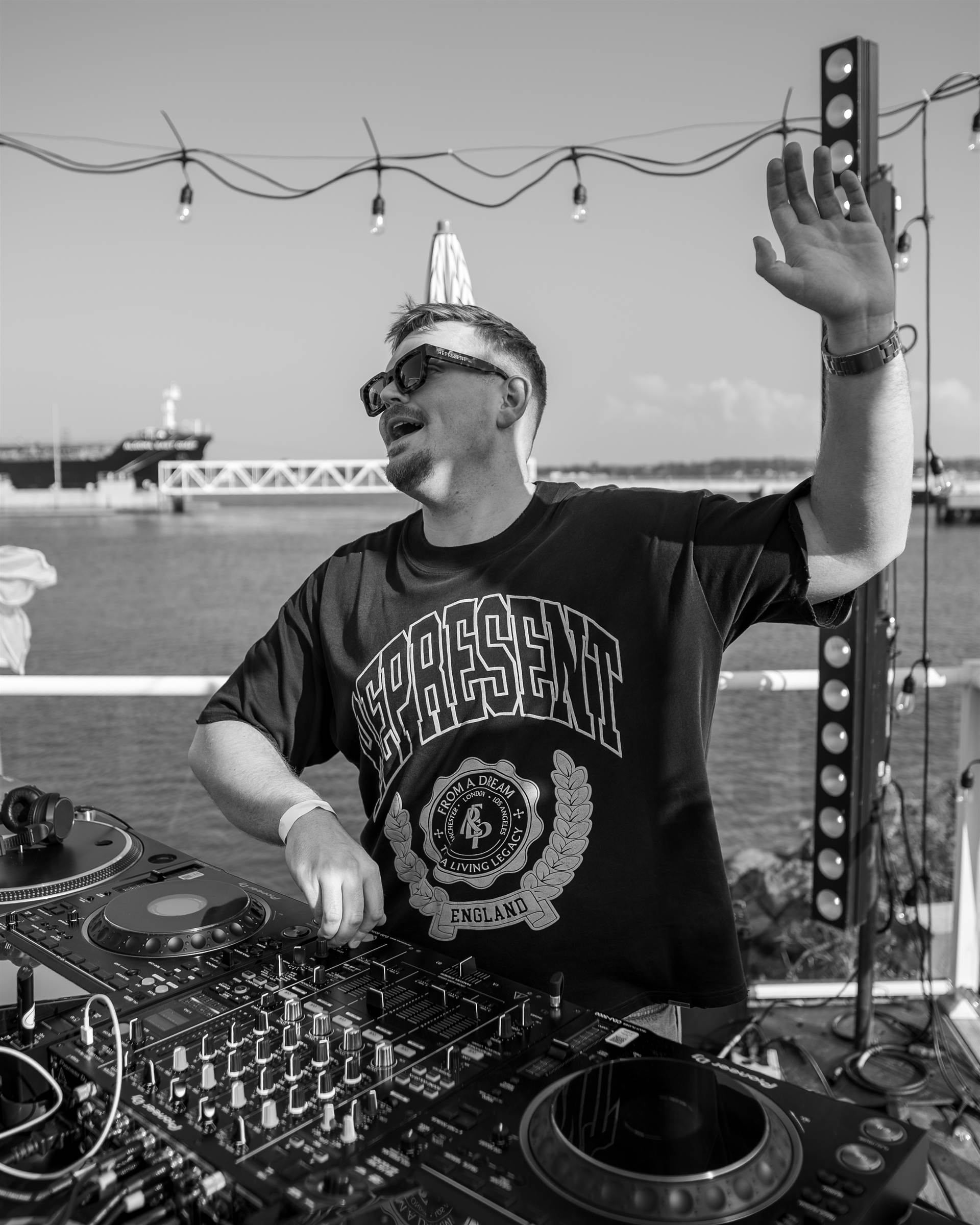 DJ duo with hands raised at night at Sundrift Sound Festival PEI - Eastside Photography