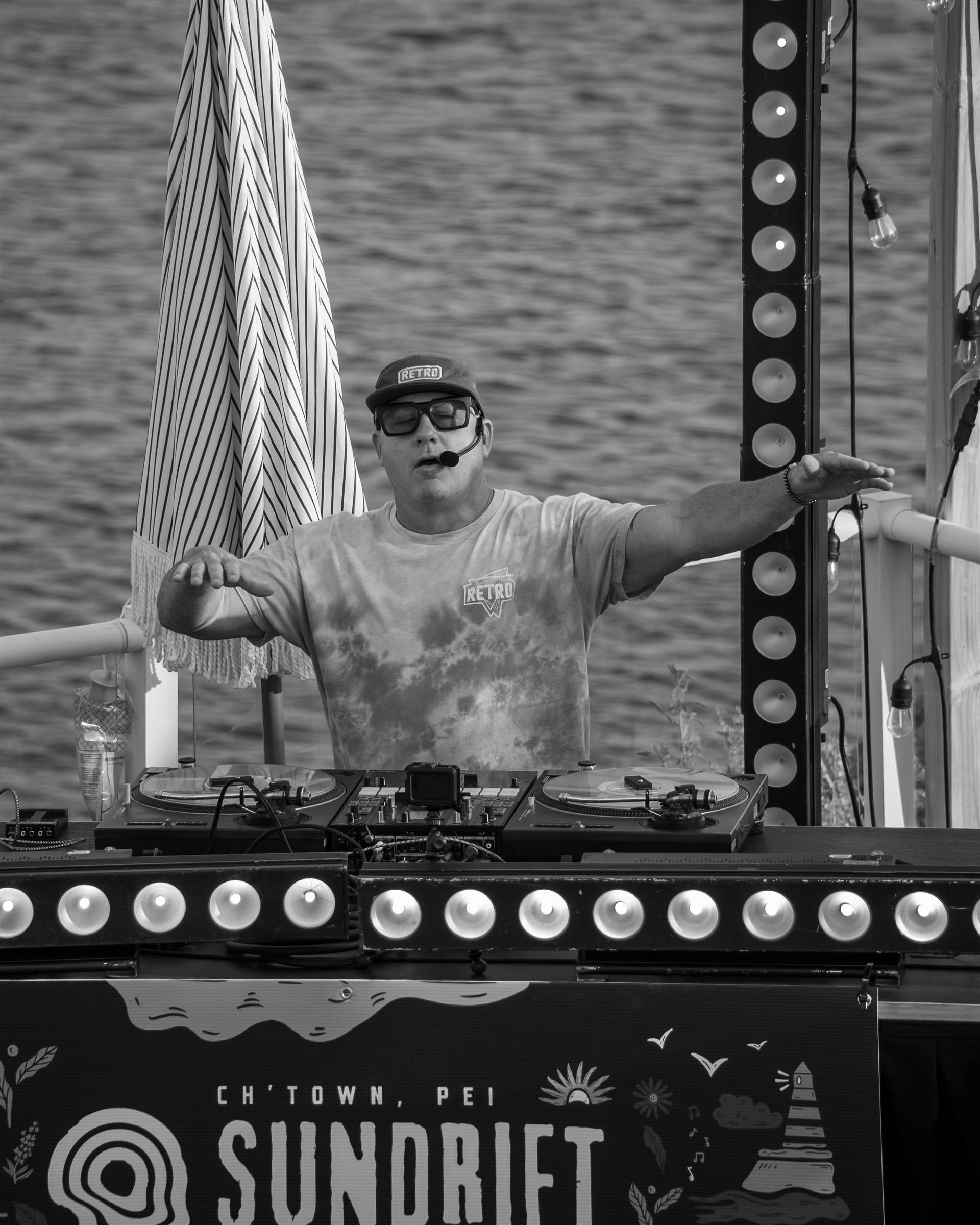 DJ in Represent shirt with Pioneer DJ light trails long exposure at Sundrift PEI - Eastside Photography