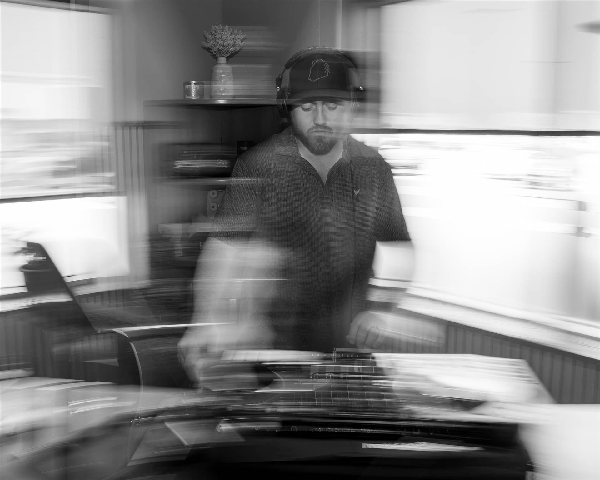 DJ with glasses and headphones at Pioneer DJ dark indoor long-exposure Sundrift PEI - Eastside Photography