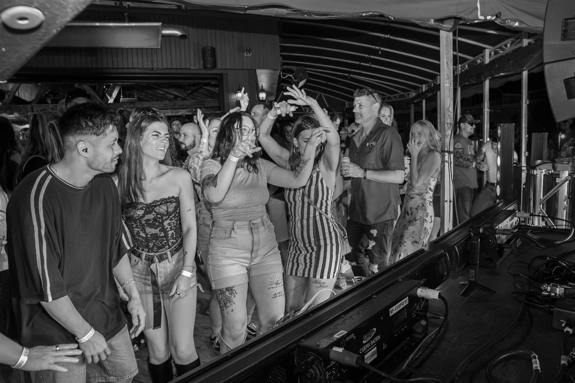 Dense crowd dancing orange warm lighting nightclub Sundrift Sound Festival PEI - Eastside Photography
